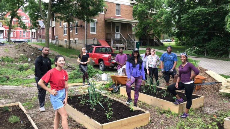 people in a community garden showing Online Gardening Communities